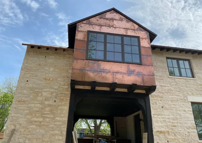 Copper metal panel facade on a stone building for Skylight Installation in Calverton